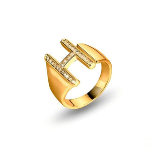 Adjustable brass letter A ring with micro-paved zirconia stones close-up, Top view of 18K gold-plated brass alphabet ring set spread on velvet, Side view of brass letter D ring worn on finger with adjustable opening, Macro shot of zirconia stone details and brass texture on alphabet ring, 
