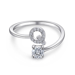 Close-up of S925 sterling silver rhodium-plated adjustable letter A ring with zirconia center stone, Top view of 26 alphabet sterling silver rings spread display with adjustable clasp detail, Side-lit shot of rhodium-plated letter S ring worn on finger with sparkling zirconia, Macro view of zirconia stone brilliance and rhodium-plated silver surface texture