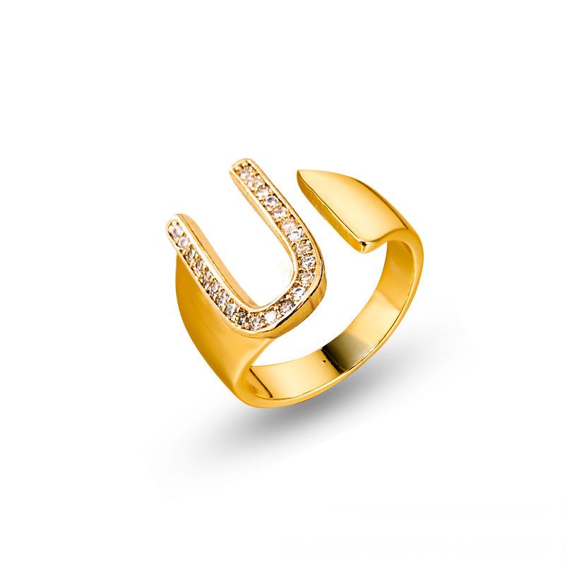 Adjustable brass letter A ring with micro-paved zirconia stones close-up, Top view of 18K gold-plated brass alphabet ring set spread on velvet, Side view of brass letter D ring worn on finger with adjustable opening, Macro shot of zirconia stone details and brass texture on alphabet ring, 