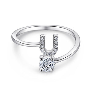 Close-up of S925 sterling silver rhodium-plated adjustable letter A ring with zirconia center stone, Top view of 26 alphabet sterling silver rings spread display with adjustable clasp detail, Side-lit shot of rhodium-plated letter S ring worn on finger with sparkling zirconia, Macro view of zirconia stone brilliance and rhodium-plated silver surface texture