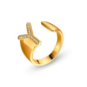 Adjustable brass letter A ring with micro-paved zirconia stones close-up, Top view of 18K gold-plated brass alphabet ring set spread on velvet, Side view of brass letter D ring worn on finger with adjustable opening, Macro shot of zirconia stone details and brass texture on alphabet ring, 