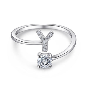 Close-up of S925 sterling silver rhodium-plated adjustable letter A ring with zirconia center stone, Top view of 26 alphabet sterling silver rings spread display with adjustable clasp detail, Side-lit shot of rhodium-plated letter S ring worn on finger with sparkling zirconia, Macro view of zirconia stone brilliance and rhodium-plated silver surface texture