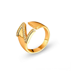 Adjustable brass letter A ring with micro-paved zirconia stones close-up, Top view of 18K gold-plated brass alphabet ring set spread on velvet, Side view of brass letter D ring worn on finger with adjustable opening, Macro shot of zirconia stone details and brass texture on alphabet ring, 
