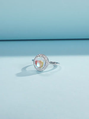 Stackable sterling silver moonstone ring on finger, Ins style moonstone ring with celestial glow, Recycled silver moonstone stacking band jewelry,Close-up of natural moonstone in silver ring setting, Minimalist moonstone ring for layered arm candy